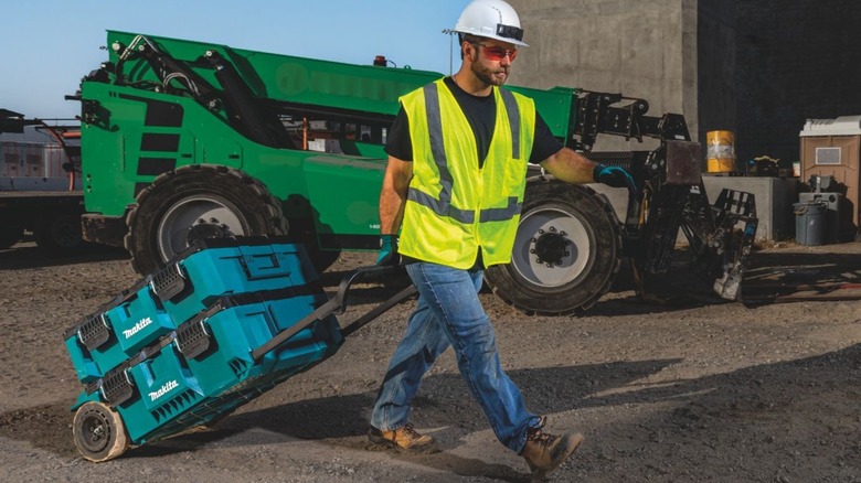 man rolling Makita's chest across jobsite