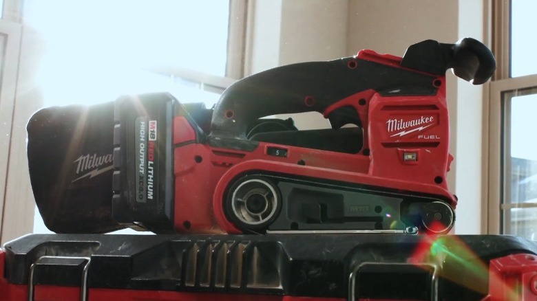 Milwaukee belt sander on table