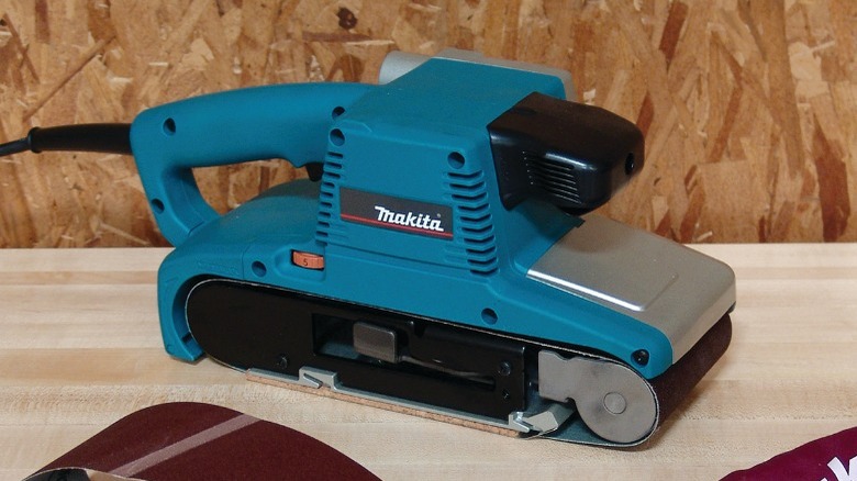 Makita belt sander on table