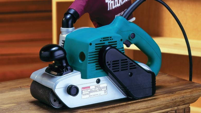 Makita belt sander on table