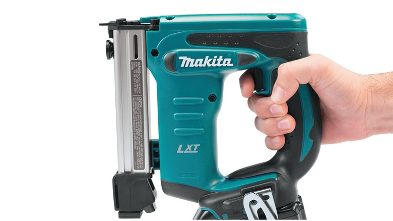 Person holding Makita crown stapler