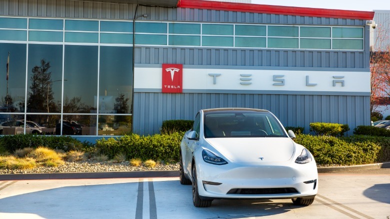 tesla vehicle in front of factory