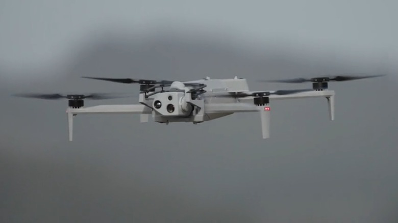 A Skydio X10D hovering over a grey backdrop