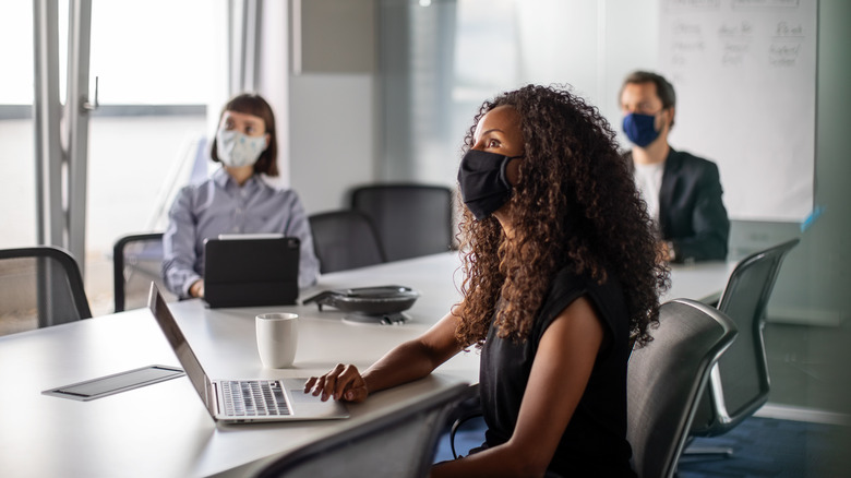 Masked workers using computers