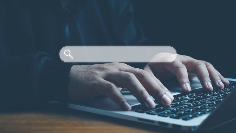 Man using laptop with virtual Search bar