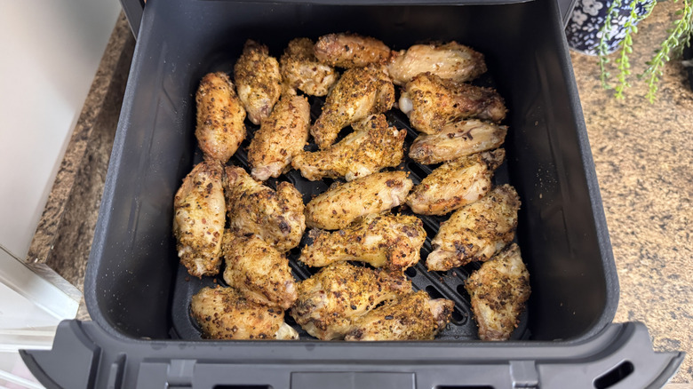 Air fried chicken wings in the Midea Two Zone Air Fryer basket