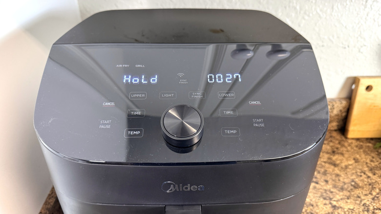 The Midea Two Zone Air Fryer showing the top capacitive buttons and dual lcd display