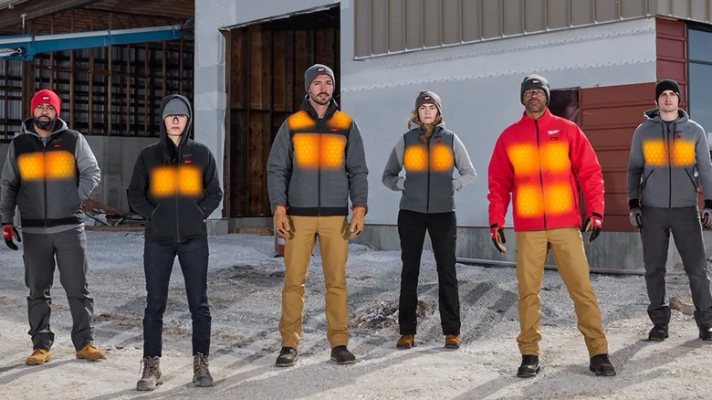 People standing outside wearing Milwaukee heated clothing