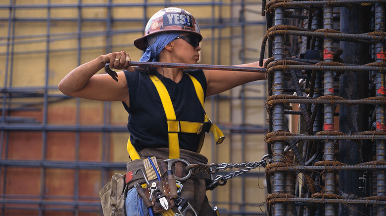 Construction worker setting up rebar framework for RCC supports