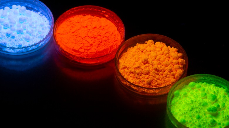 Fluorescent organic materials powder of red, yellow, green color for production OLED inside of glasses bottles in UV light.