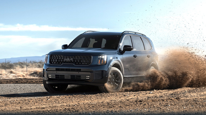 KIA Telluride driving aggressively on a dirt road