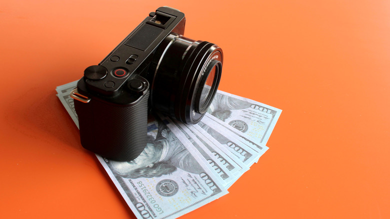 Mirrorless camera sitting on a stack of money