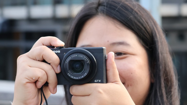 Woman using compact camera