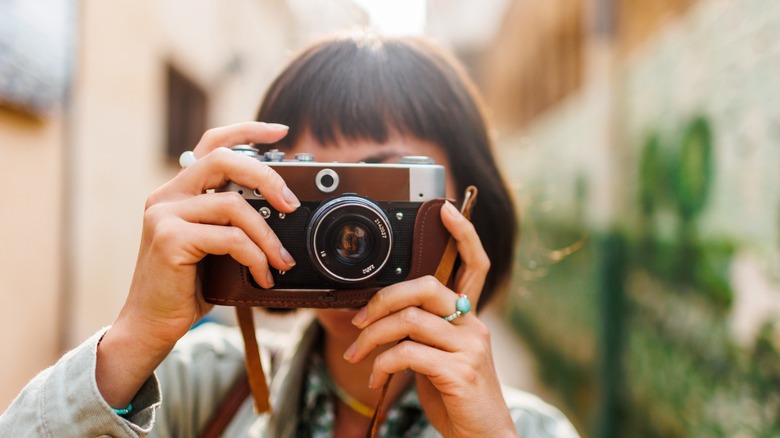 person taking film photos