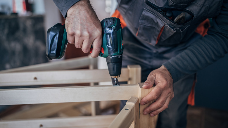 Man using a cordless drill on wood