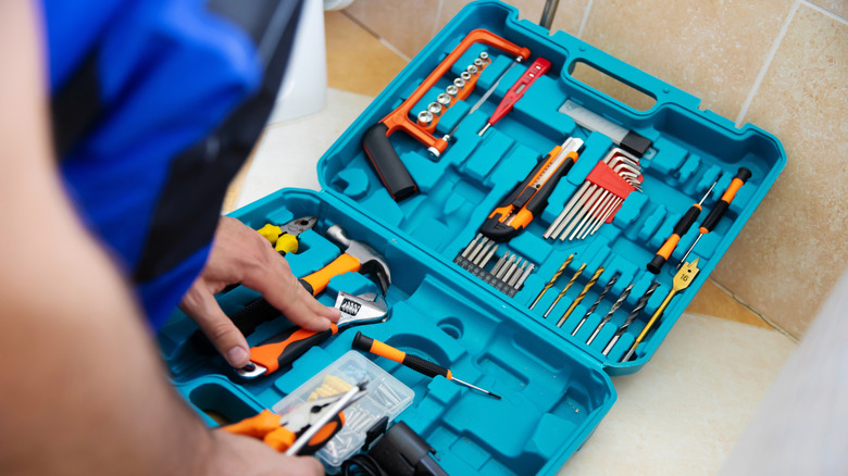 Open toolbox containing various drill bits