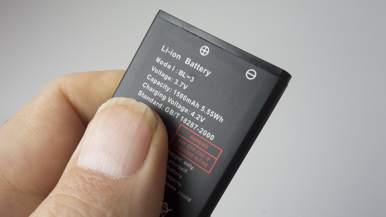 Hand holding lithium ion battery