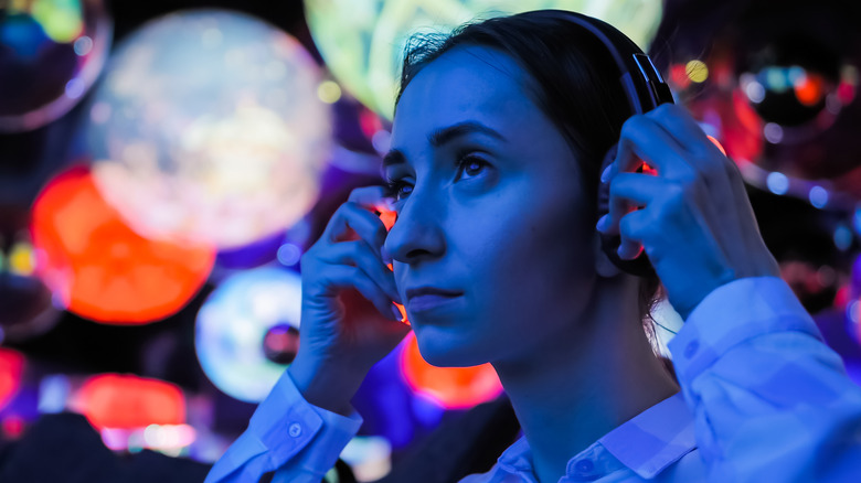 A woman trying on Bluetooth headphones