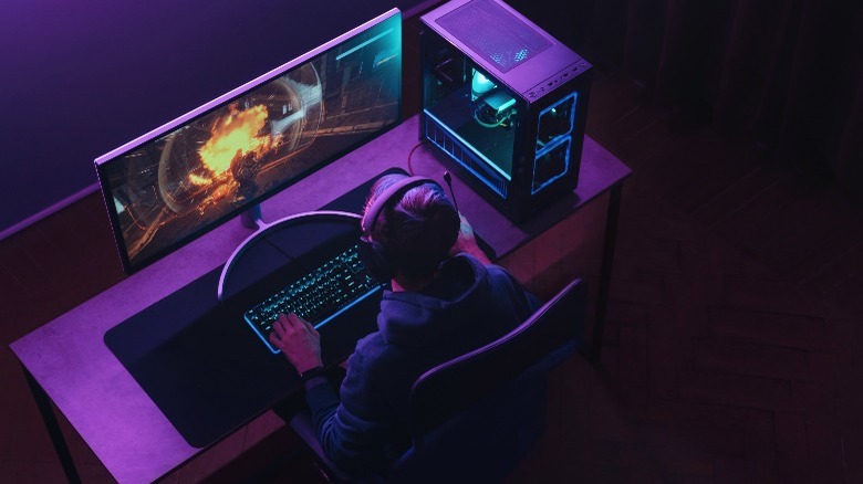 Man gaming on computer with a headset on