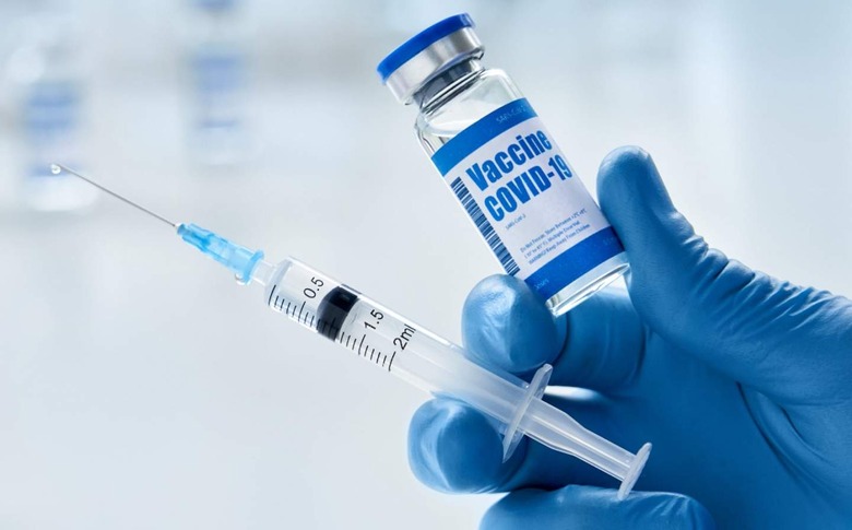 COVID vaccine syringe in hand