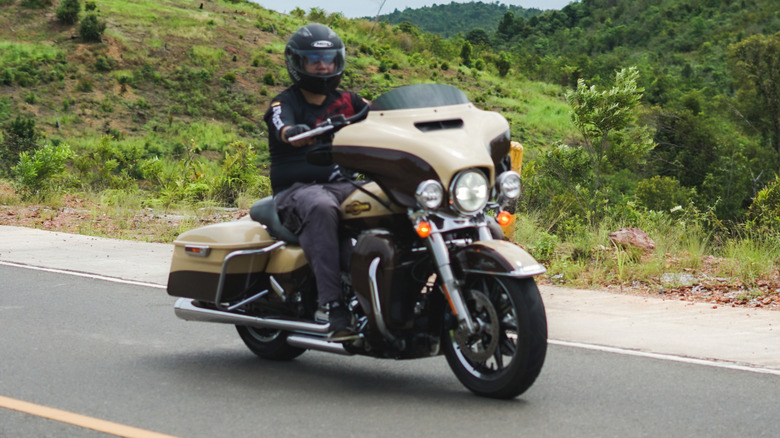 A person riding a Harley Davidson