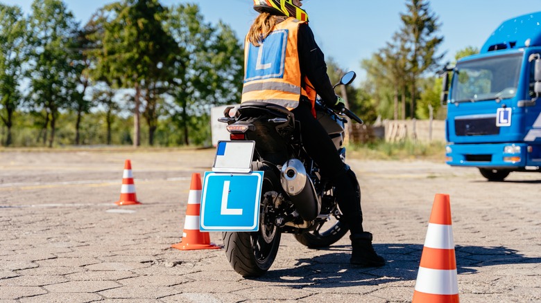 person taking lessons to learn how to ride motorcycle