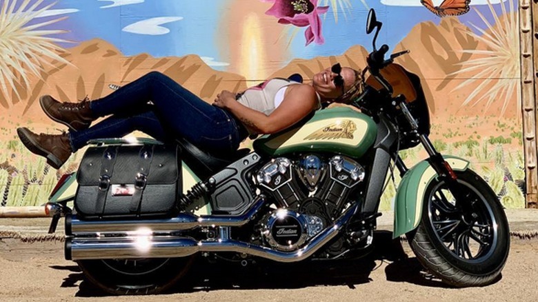 Pink laying on motorcycle