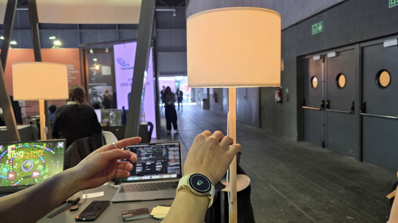 A man adjusts a lamp with his smartwatch