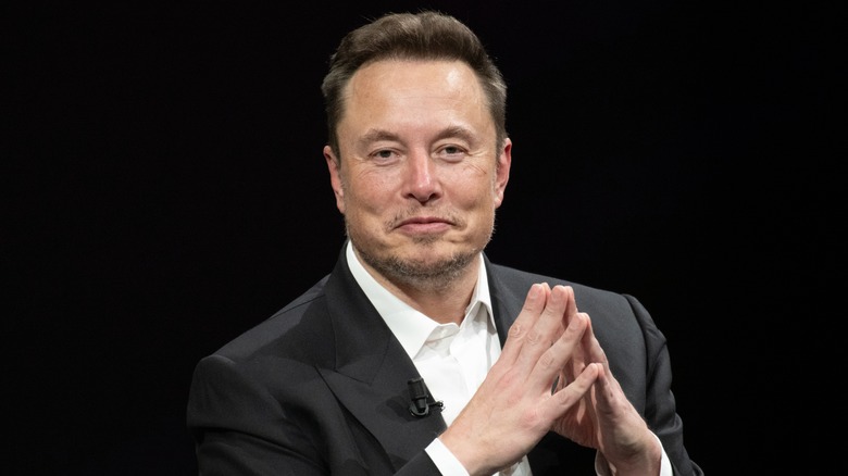 Elon Musk smiling sheepishly
