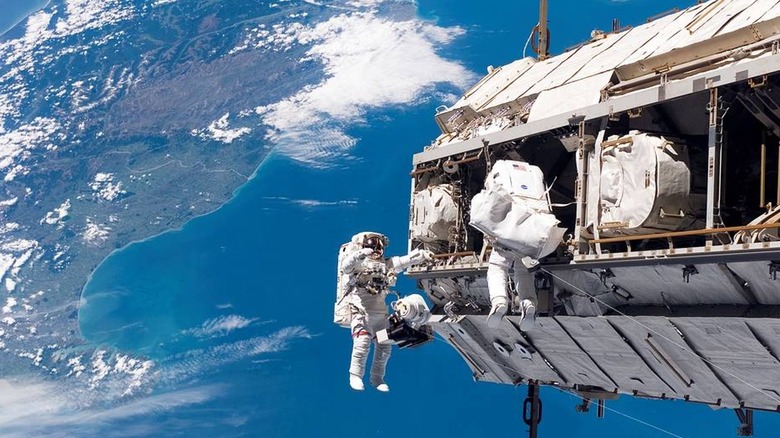 Astronauts constructing the International Space Station