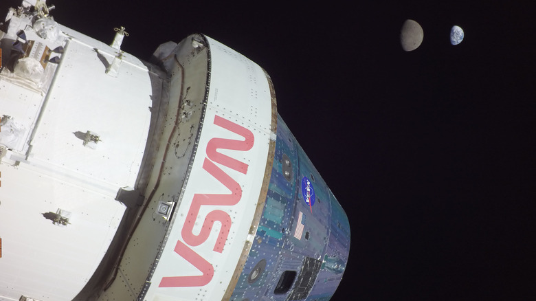 NASA's Orion with Earth and Moon in the background.