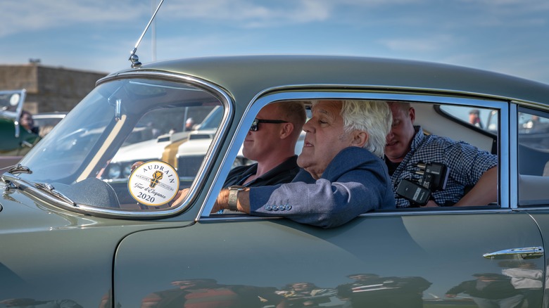 Jay Leno driving a classic car