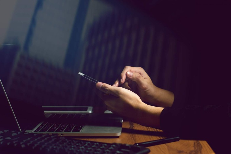 Man using phone and laptop