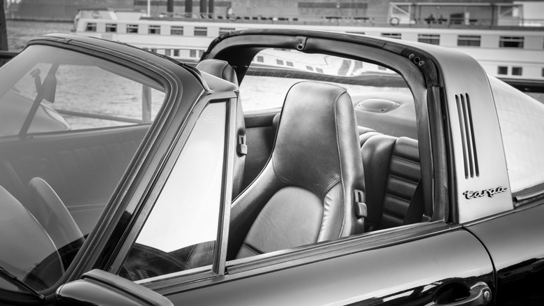 Porsche 911 targa with roof down zoomed in to show targa-top detail, driver's side, in grayscale