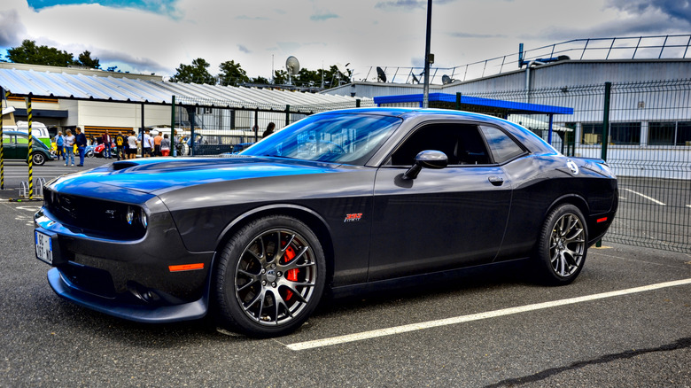 A side view of a black Dodge Challenger SRT Hellcat.