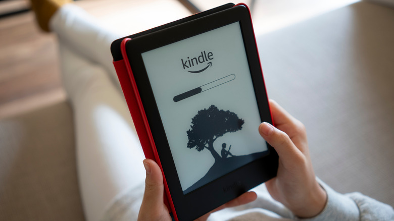 kindle paperwhite with red cover being read