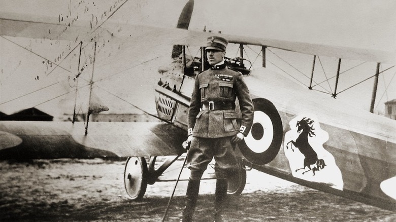 Italian pilot in front of World War I aircraft