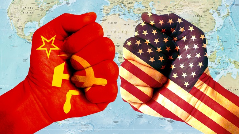 Cold War reflected by Soviet symbol and American flag on fists