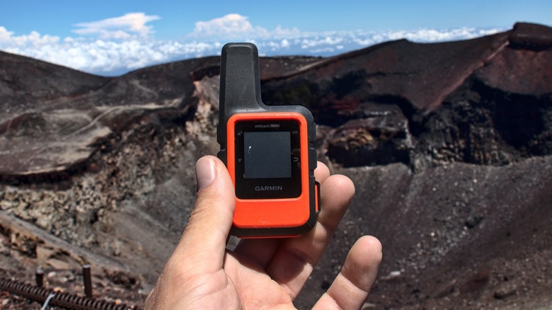 Person holding Garmin inReach Mini