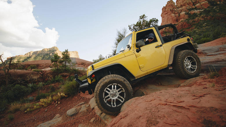 Off-road vehicle driving down rocky mountain