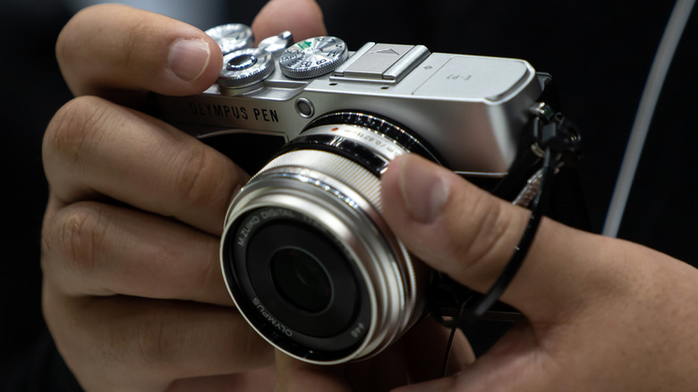 Person using Olympus Pen camera