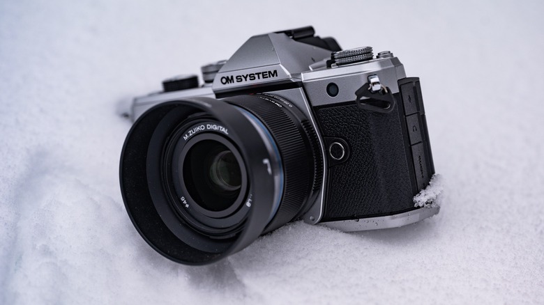 The OM System OM-3 in a snow bank.