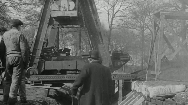 French Boirault Machine Tank going over trench with men watching