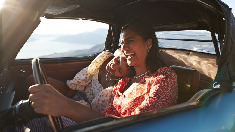 Two women in a car wearing no seat belts