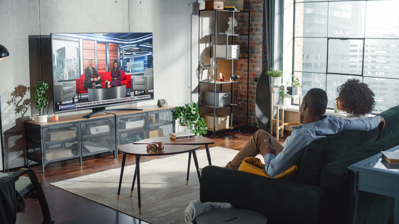 couple watching tv on couch