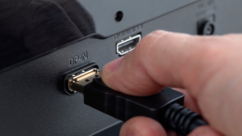 A DisplayPort cable is plugged into a monitor