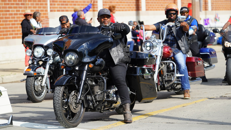 Motorcyclists sitting on motorcycles in street