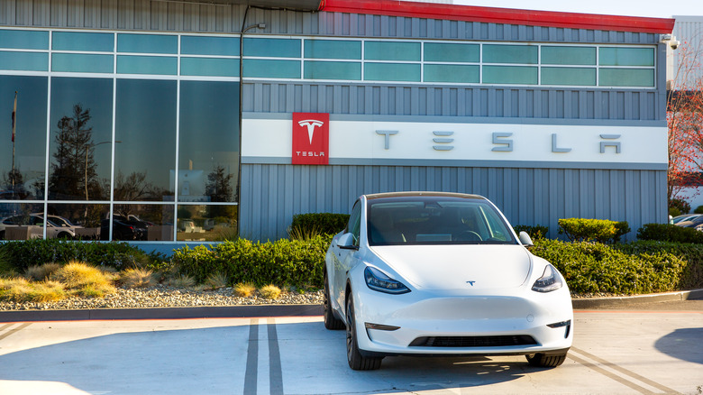 Tesla in front of dealership