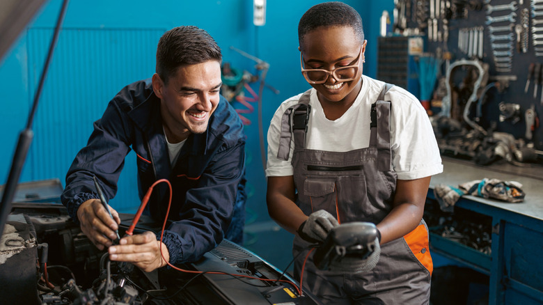 Mechanics checking car engine