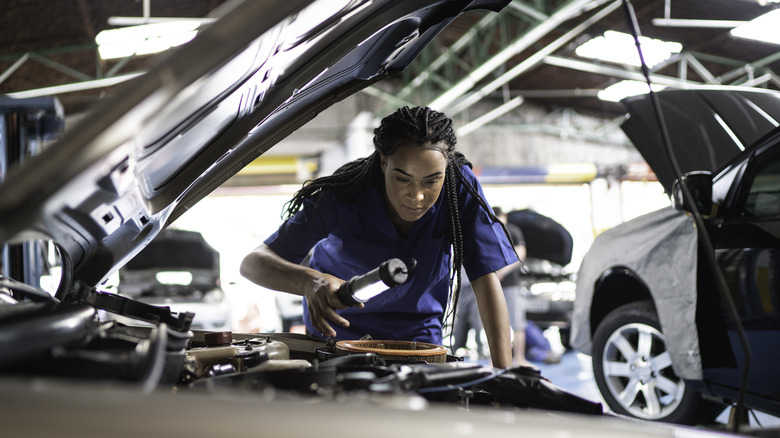 mechanic inspecting car engine